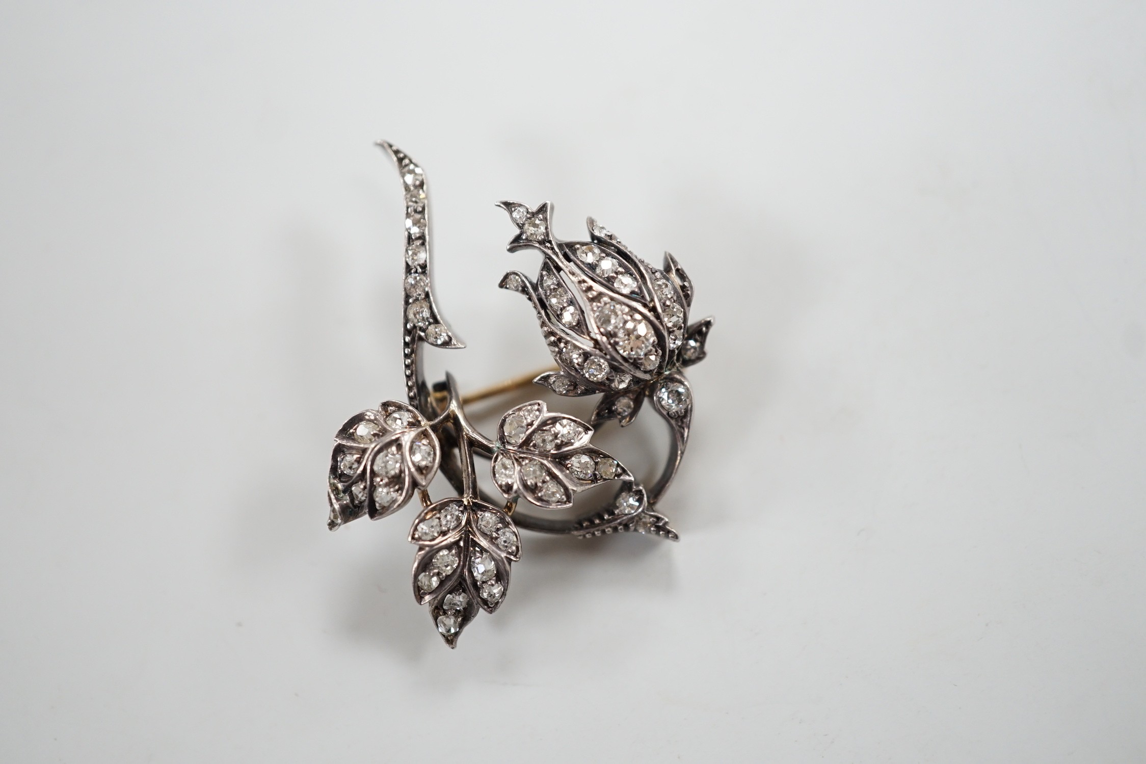 A Victorian yellow and white metal and diamond cluster set spray brooch, 38mm, gross weight 8.9 grams.